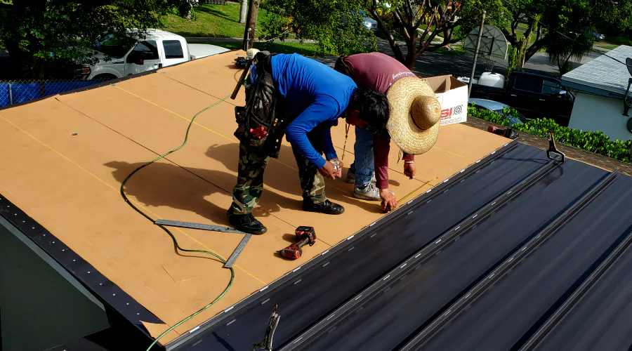 bilantar inc team members working on metal roof reroofing miami gardens fl