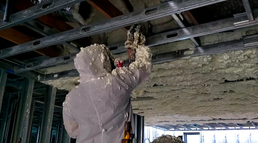 contractor spraying foam insulation into a houses ceiling miami gardens fl